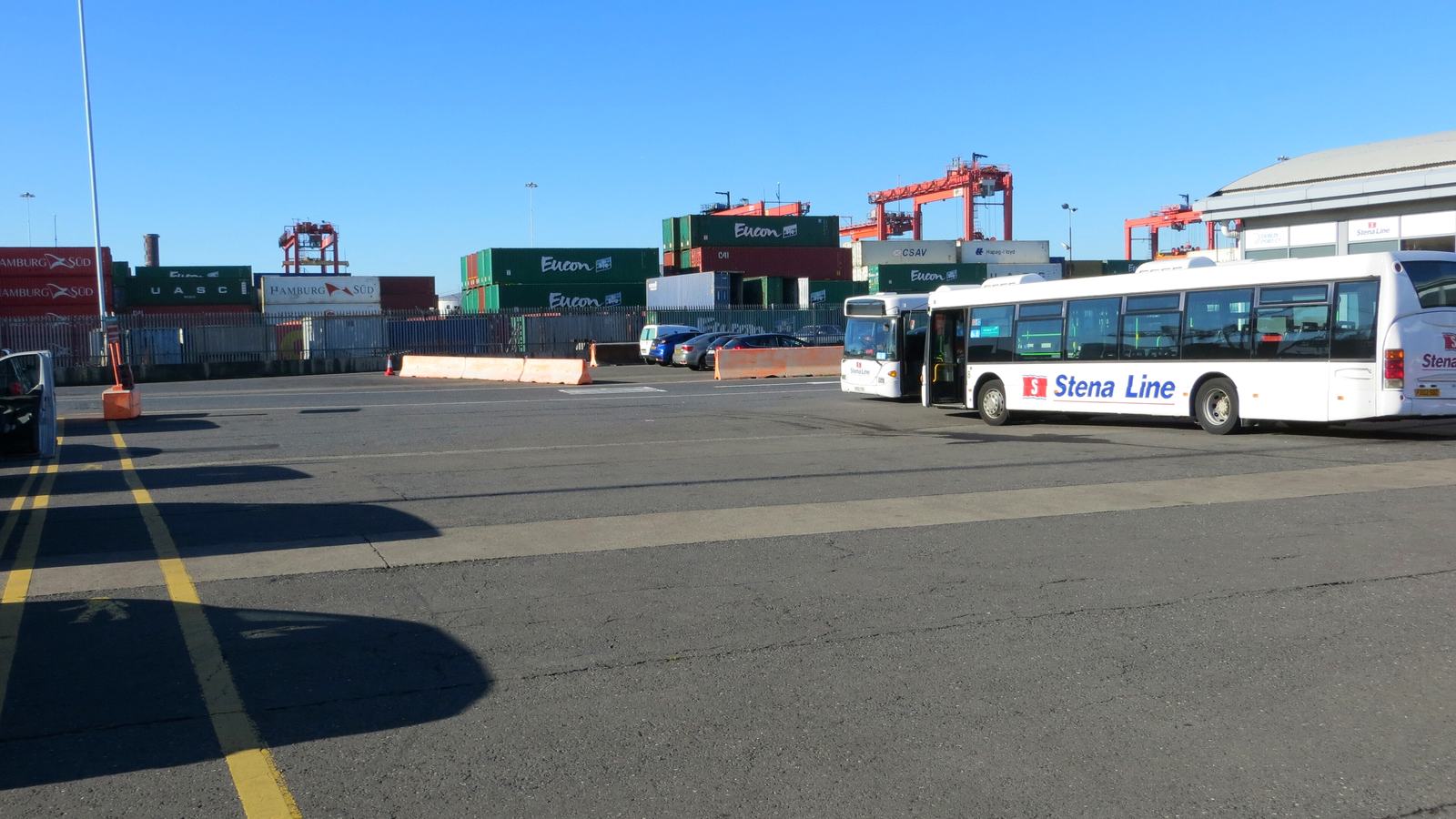 Stena Line buses parked on the concourse at Terminal 2, Dublin Port, with container stacks and cranes behind
